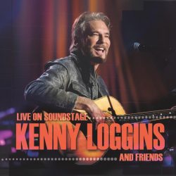 kenny loggins on stage holding acoustic guitar