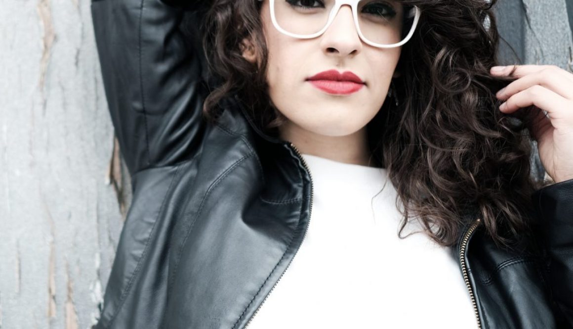 December Rose wearing white shirt and black leather jacket and white glasses