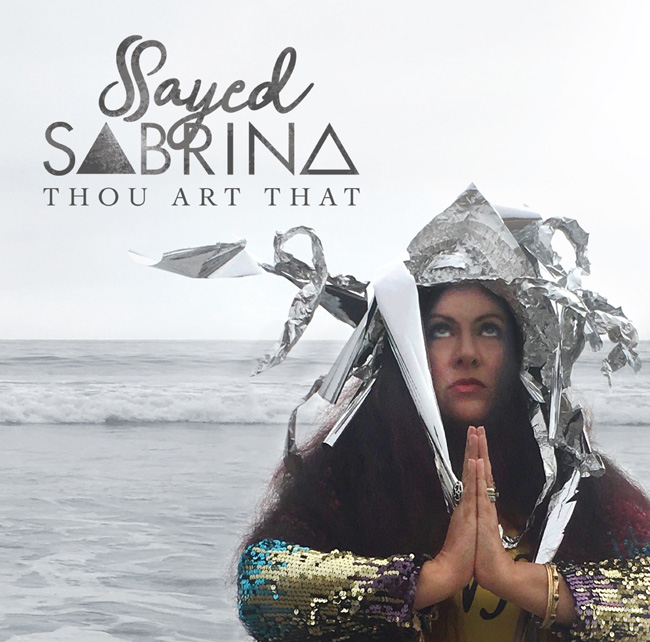 sayed sabrina wearing sequin dress and tin foil hat at beach