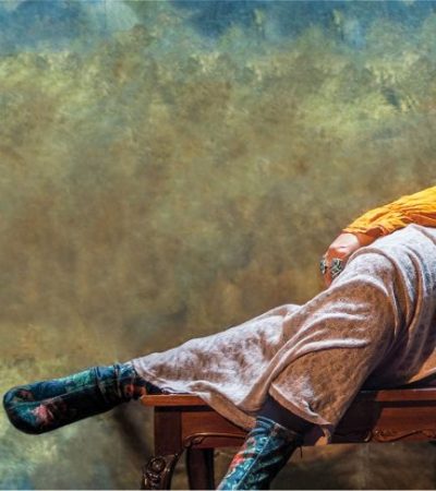 sayed sabrina laying on couch with yellow sweeter and flowered dress