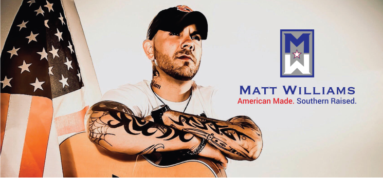 matt williams wearing white tshirt crossing arms over acoustic guitar with american flag